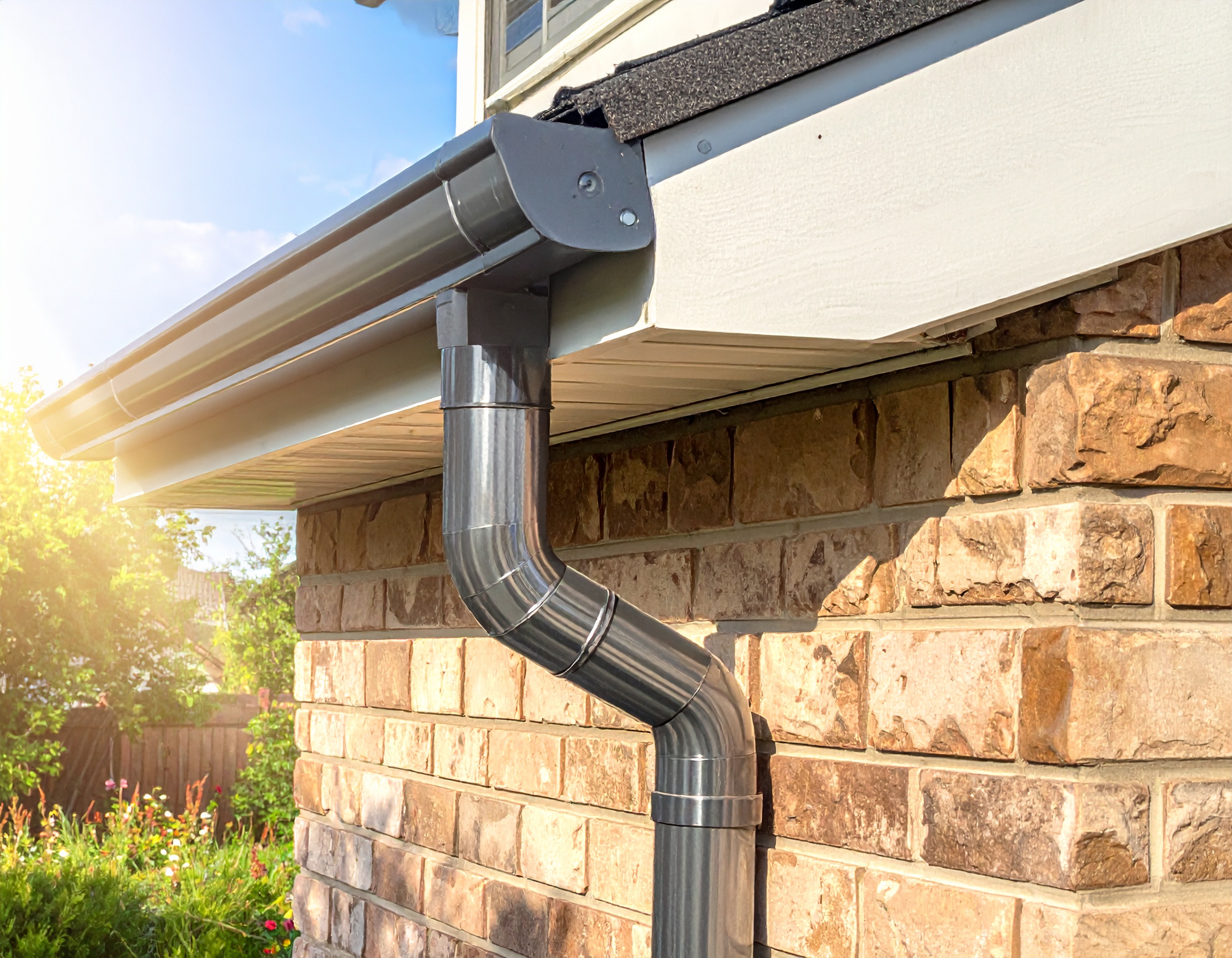 Gutter repair and downspout connection on a residential property