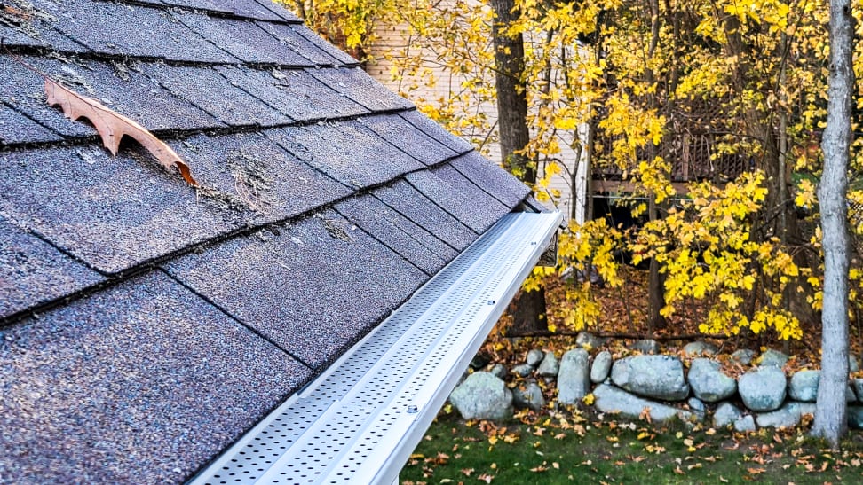 Gutter screen or guard installed to block leaves and debris